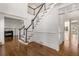 Bright foyer with hardwood floors, a beautiful staircase, and an open floor plan leading to a living area at 5080 Riverlake Dr, Peachtree Corners, GA 30097