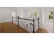 Hallway with hardwood floors, white railings, and elegant chandelier at 5080 Riverlake Dr, Peachtree Corners, GA 30097