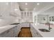 Bright kitchen boasts white cabinets, sleek countertops, and modern fixtures at 5080 Riverlake Dr, Peachtree Corners, GA 30097