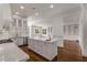 Bright, open kitchen with stainless steel appliances and view of the living room at 5080 Riverlake Dr, Peachtree Corners, GA 30097