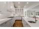 Spacious kitchen with white cabinets, stainless steel appliances, a center island, and hardwood floors at 5080 Riverlake Dr, Peachtree Corners, GA 30097