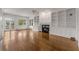 Bright living room featuring hardwood floors, built-in bookshelves, and a cozy fireplace at 5080 Riverlake Dr, Peachtree Corners, GA 30097