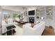 Cozy living room with white sofas, modern decor, built-in shelves, and a ceiling fan at 5080 Riverlake Dr, Peachtree Corners, GA 30097