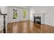 Bright living room features a fireplace, large windows, and hardwood floors at 5080 Riverlake Dr, Peachtree Corners, GA 30097