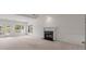 Spacious living room featuring a fireplace, ceiling fan, and access to outdoor patio at 5080 Riverlake Dr, Peachtree Corners, GA 30097
