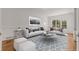 Cozy living room with stylish furnishings, plush sofas, and a patterned rug at 5080 Riverlake Dr, Peachtree Corners, GA 30097