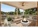 Beautiful covered patio with a fire pit and view of the lake and trees at 5080 Riverlake Dr, Peachtree Corners, GA 30097