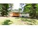 Expansive backyard featuring a porch, mature trees, and a well-maintained lawn at 8169 Kendrick Rd, Jonesboro, GA 30238