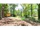 Lush backyard with mature trees, offering privacy and a serene setting at 8169 Kendrick Rd, Jonesboro, GA 30238