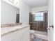 Bathroom featuring a granite countertop vanity and decorative tile shower at 8169 Kendrick Rd, Jonesboro, GA 30238