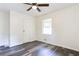 Cozy bedroom featuring hardwood floors, a ceiling fan, window, and a closet at 8169 Kendrick Rd, Jonesboro, GA 30238