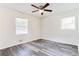 A well-lit bedroom with hardwood floors, neutral walls, and a contemporary ceiling fan at 8169 Kendrick Rd, Jonesboro, GA 30238