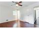 Bright bedroom featuring hardwood floors, a ceiling fan, and a window providing natural light at 8169 Kendrick Rd, Jonesboro, GA 30238