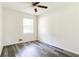 A well-lit bedroom with hardwood floors, neutral walls, and a contemporary ceiling fan at 8169 Kendrick Rd, Jonesboro, GA 30238