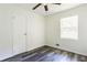 Cozy bedroom featuring hardwood floors, a ceiling fan, window, and a closet at 8169 Kendrick Rd, Jonesboro, GA 30238