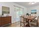 Dining area with light wood floors, natural light, and access to the outdoor patio at 8169 Kendrick Rd, Jonesboro, GA 30238