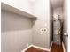 A practical utility room with dark wood flooring, shelving, and a modern water heater at 8169 Kendrick Rd, Jonesboro, GA 30238