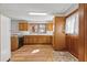 Traditional kitchen with wood cabinets, white appliances, and bright natural light at 3107 Hammock Creek Ct, Conyers, GA 30012