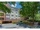 Exterior view showcasing the building, lush greenery, parking and landscaping at 3636 Habersham Rd # 2307, Atlanta, GA 30305