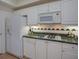 Well-lit kitchen features white cabinets and refrigerator and gas stove at 3636 Habersham Rd # 2307, Atlanta, GA 30305