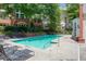 Community pool with lounge chairs and lush green landscaping at 3636 Habersham Rd # 2307, Atlanta, GA 30305