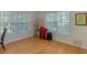 Well-lit spare room with hardwood floors and two windows with wood blinds at 3636 Habersham Rd # 2307, Atlanta, GA 30305
