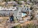 Aerial view of the building with a swimming pool, tennis court, and lush green landscaping at 4007 Westchester Ne Rdg, Brookhaven, GA 30329
