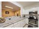 Updated kitchen showcasing white cabinets, stainless appliances, and a granite-topped bar at 4007 Westchester Ne Rdg, Brookhaven, GA 30329