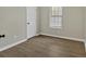 Bedroom with wood-look flooring, natural light, and neutral paint at 4384 Raven Valley Ct, Decatur, GA 30035