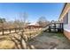 Expansive backyard featuring a deck, fencing, and a charming red barn-style outbuilding at 527 Main St, Suwanee, GA 30024