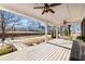 Covered front porch with white ceiling, ceiling fans, wood floors, and serene views of surrounding landscape at 527 Main St, Suwanee, GA 30024