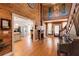 Open living room featuring wood walls, hardwood floors, and an opening into the spacious kitchen at 527 Main St, Suwanee, GA 30024