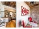 Patio area featuring a vintage Coca-Cola sign, red chairs, and view into the living room at 527 Main St, Suwanee, GA 30024