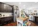 Spacious kitchen features stainless appliances, dark wood cabinets, and a butcher block island at 7730 Pierpoint Ln, Alpharetta, GA 30005