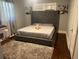 Comfortable bedroom with a large gray bed, soft rug, and decorative wall art at 1441 Evans Dr, Riverdale, GA 30296