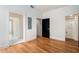 Bright bedroom featuring hardwood floors, and a open doorway at 165 Breakspear Ln, Fayetteville, GA 30214