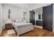 Bedroom with hardwood floors, barn door leading to bathroom, and light neutral colors at 165 Breakspear Ln, Fayetteville, GA 30214