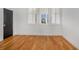 Bedroom featuring hardwood floors, white walls, black doors, and ample light at 165 Breakspear Ln, Fayetteville, GA 30214