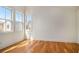 Bedroom featuring hardwood floors, three windows, and white walls at 165 Breakspear Ln, Fayetteville, GA 30214