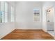 Bright bedroom featuring hardwood floors, white walls, and multiple windows for natural light at 165 Breakspear Ln, Fayetteville, GA 30214