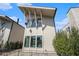 A contemporary home featuring a light exterior with dark-trim windows and a unique roofline at 165 Breakspear Ln, Fayetteville, GA 30214