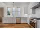 Modern kitchen with white cabinets, stainless steel appliances, and hardwood flooring at 165 Breakspear Ln, Fayetteville, GA 30214