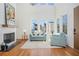 Sun-filled living room featuring a fireplace, hardwood floors, large windows, and comfortable seating arrangement at 165 Breakspear Ln, Fayetteville, GA 30214