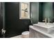 This powder room features a vessel sink, marble countertop, dark green paint, and a window for natural light at 165 Breakspear Ln, Fayetteville, GA 30214