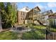 Spacious backyard featuring a fire pit, screened porch and lush green landscaping at 1696 N Pelham Ne Rd, Atlanta, GA 30324