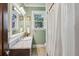 Cozy bathroom featuring a granite vanity, tile floors, and a combination shower/tub at 1696 N Pelham Ne Rd, Atlanta, GA 30324