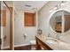 Neutral bathroom with a round mirror, a stone countertop, and a glass shower at 1696 N Pelham Ne Rd, Atlanta, GA 30324