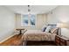 Simple bedroom with a bed, a window, and hardwood floors at 1696 N Pelham Ne Rd, Atlanta, GA 30324