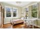 Sunlit bedroom with hardwood floors, large windows, and a writing desk at 1696 N Pelham Ne Rd, Atlanta, GA 30324