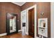 Hallway with rich wood floors, textured wallpaper, and doorways to the adjacent rooms at 1696 N Pelham Ne Rd, Atlanta, GA 30324